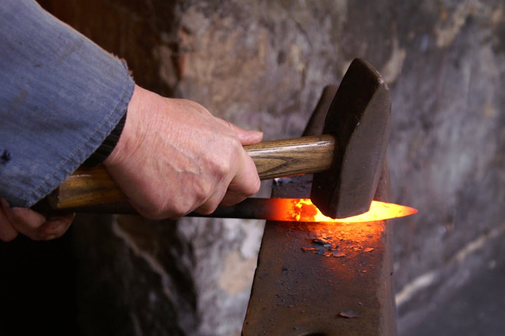 Person Holding Forging Metal